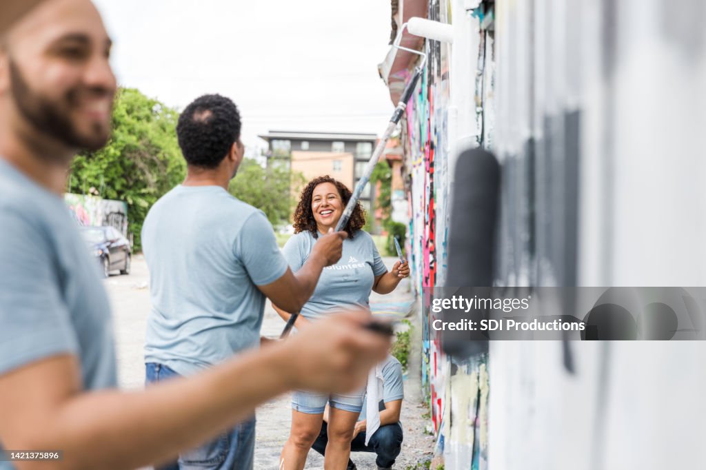 Coworkers painting at the volunteer event