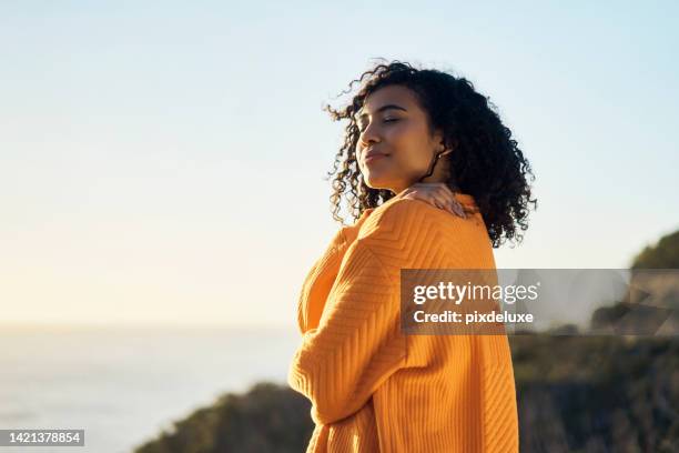 relax, beach or summer with a woman outdoor and the horizon, sea or ocean in the background during summer. freedom, self love and nature with a young female on holiday or vacation and hugging herself - open minded stock pictures, royalty-free photos & images