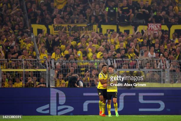 Jude Bellingham celebrates with Giovanni Reyna of Borussia Dortmund after scoring their team's third goal during the UEFA Champions League group G...