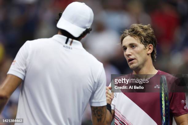 Casper Ruud of Norway shakes hands after defeating Matteo Berrettini of Italy during their Men’s Singles Quarterfinal match on Day Nine of the 2022...