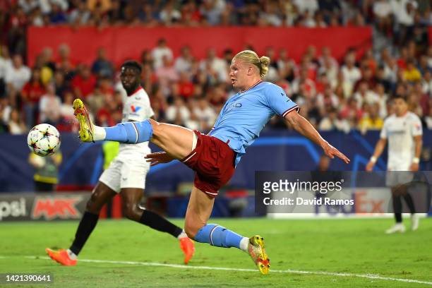 Erling Haaland of Manchester City scores their side's first goal during the UEFA Champions League group G match between Sevilla FC and Manchester...