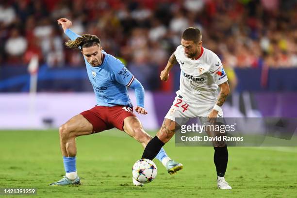 Jack Grealish of Manchester City battles for possession with Alejandro Gomez of Sevilla FC during the UEFA Champions League group G match between...