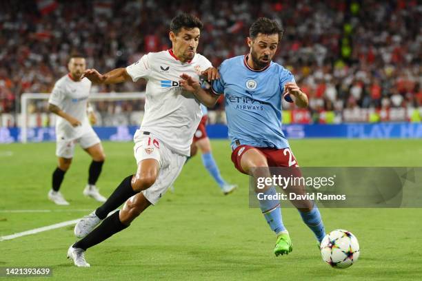 Jesus Navas of Sevilla FC battles for possession with Bernardo Silva of Manchester City during the UEFA Champions League group G match between...