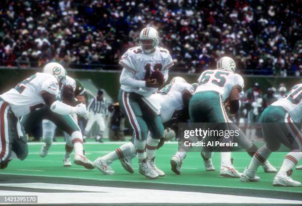 Quarterback Dan Marino of the Miami Dolphins turns to hand off the ball in the game between the Miami Dolphins vs the New York Jets at The...