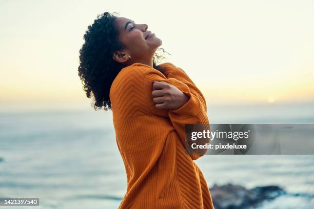 black woman self love, beach sunset travel and relax in peace sea breeze. girl outdoor in blue sky leisure, ocean sunrise wellness, meditation lifestyle and breathe winter air alone on dream holiday. - black spirituality stock pictures, royalty-free photos & images