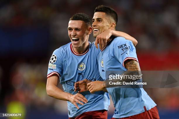 Phil Foden of Manchester City celebrates after scoring their side's second goal with Joao Cancelo during the UEFA Champions League group G match...