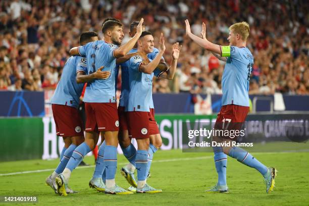 Phil Foden of Manchester City celebrates after scoring their side's second goal with Ruben Dias and Kevin De Bruyne during the UEFA Champions League...