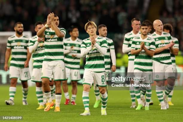 Kyogo Furuhashi of Celtic applauds the fans with teammates following their sides defeat in the UEFA Champions League group F match between Celtic FC...