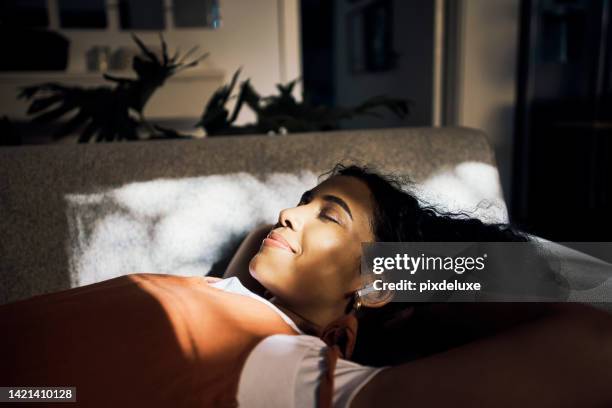 happy girl sleeping on bed in bedroom, listening to music and streaming audio podcast in free time in house. freedom, relax and wellness for black woman with radio, calm playlist and stress relief - listening to radio stock pictures, royalty-free photos & images