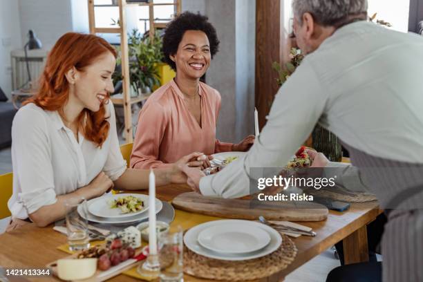 happy people sharing their lunch - party host stock pictures, royalty-free photos & images