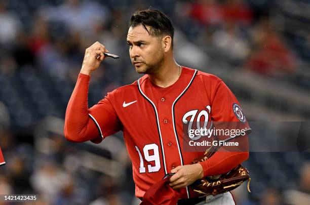 Anibal Sanchez of the Washington Nationals checks the PitchCom device during the game against the Oakland Athletics at Nationals Park on August 31,...