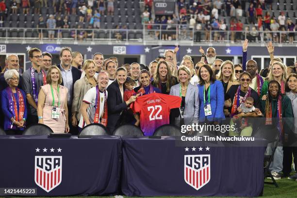 Members of U.S. Soccer, the U.S. Women's National Team Players Association and other dignitaries pose for a photo after signing a collective...