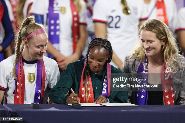 Crystal Dunn signs a collective bargaining agreement signing signifying equal pay between the U.S. Men's and women's national soccer teams at Audi...