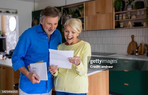 happy couple reading good news in the mail - good news stock pictures, royalty-free photos & images