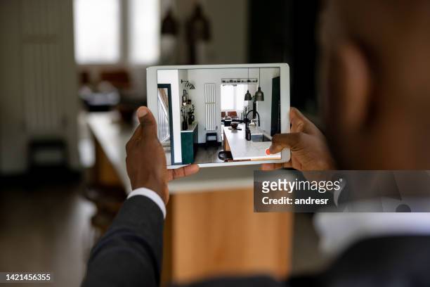 real estate agent making a virtual tour of a house using a tablet - travel real people stockfoto's en -beelden