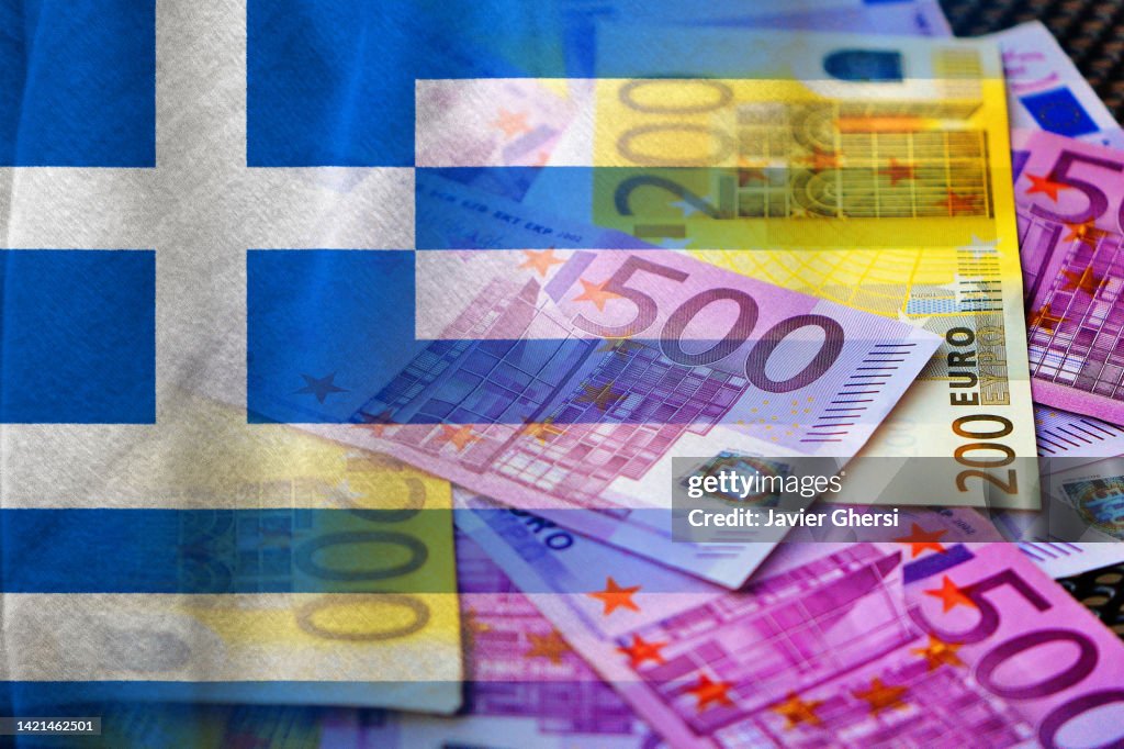 Euro cash banknotes and flag of Greece