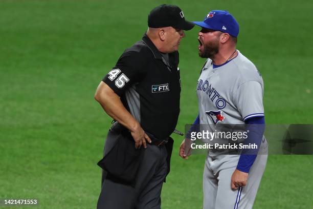 Manager John Schneider of the Toronto Blue Jays yells at umpire Jeff Nelson after being ejected against the Baltimore Orioles at Oriole Park at...