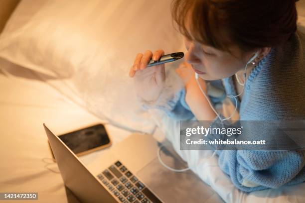 stressful woman smoking electronic cigarette for relax. - vaping danger stock pictures, royalty-free photos & images