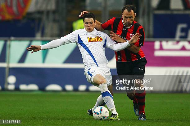 Daniel Ginczek of Bochum is challenged by Gordon Schildenfeld of Frankfurt during the Second Bundesliga match between Eintracht Frankfurt and VfL...
