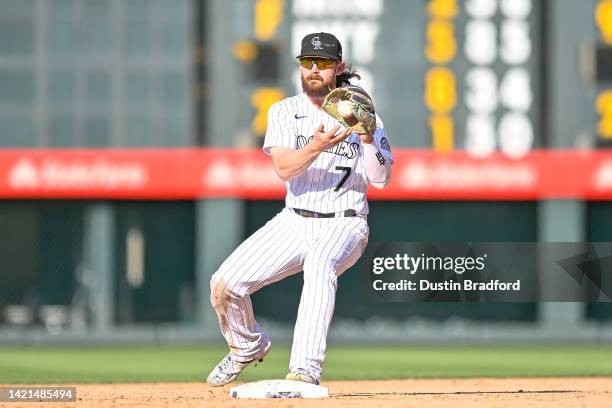 Brendan Rodgers of the Colorado Rockies fields a throw for a force out in the ninth inning of a game against the Milwaukee Brewers at Coors Field on...