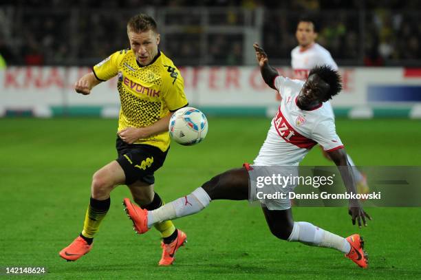 Jakub Blaszczykowski of Dortmund is challenged by Arthur Etienne Boka of Stuttgart during the Bundesliga match between Borussia Dortmund and VfB...