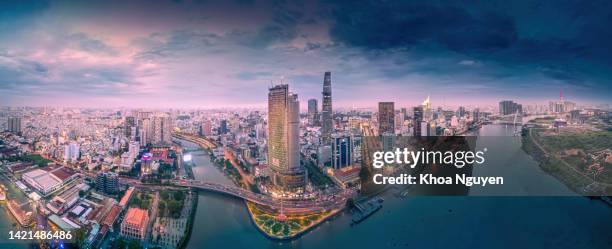 aerial view of bitexco and ifc one saigon tower, buildings, roads, thu thiem 2 bridge and saigon river in ho chi minh city - far away is landmark 81 skyscraper. travel concept. - saigon river stock pictures, royalty-free photos & images