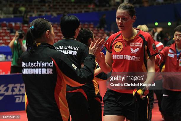 Wu Jiaduo comforts Irene Ivancan of Germany after losing against Wang Yuegu of Singapore during the LIEBHERR table tennis team world cup 2012...