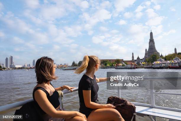 woman discover bangkok riding a boat in chao phraya river looking out from the boat - turistbåt bildbanksfoton och bilder
