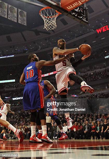 Carlos Boozer of the Chicago Bulls rebounds over Greg Monroe of the Detroit Pistons at the United Center on March 30, 2012 in Chicago, Illinois. NOTE...