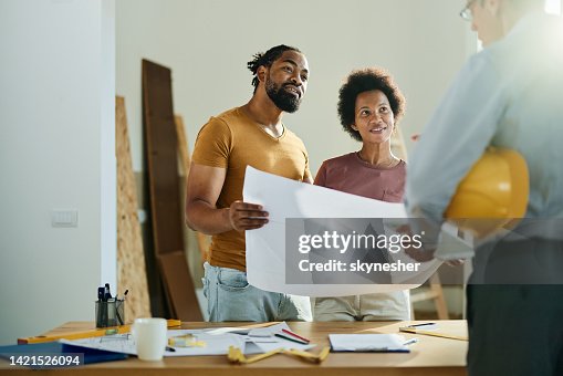 Happy black couple talking to real estate agent in the apartment. Happy black couple talking to real estate agent in the apartment.