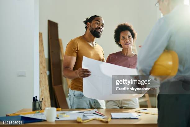 happy black couple talking to real estate agent in the apartment. - building contractor bildbanksfoton och bilder