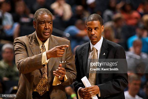 Paul Silas, head coach of the Charlotte Bobcats, left, and Stephen Silas, assistant coach, direct their team against the Denver Nuggets at the Time...