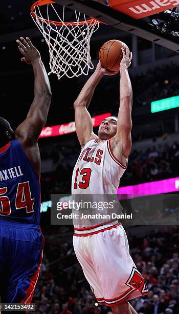Joakim Noah of the Chicago Bulls goes up for a dunk against Jason Maxiell of the Detroit Pistons at the United Center on March 30, 2012 in Chicago,...