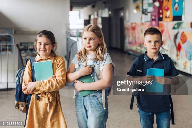 three elementary school children in a row - class photo stock pictures, royalty-free photos & images