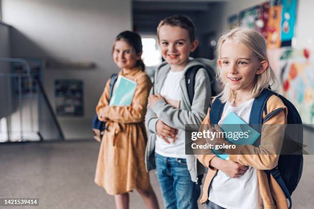 three elementary school children  in a row - class photo stock pictures, royalty-free photos & images