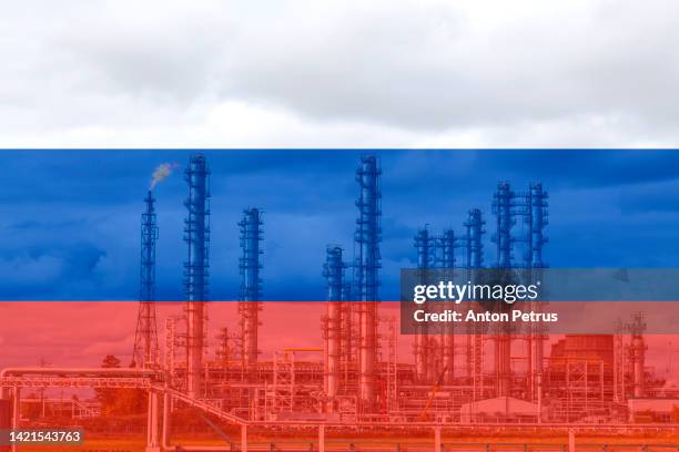 liquid natural gas plant on the background of of the russian flag - russia oil stock pictures, royalty-free photos & images