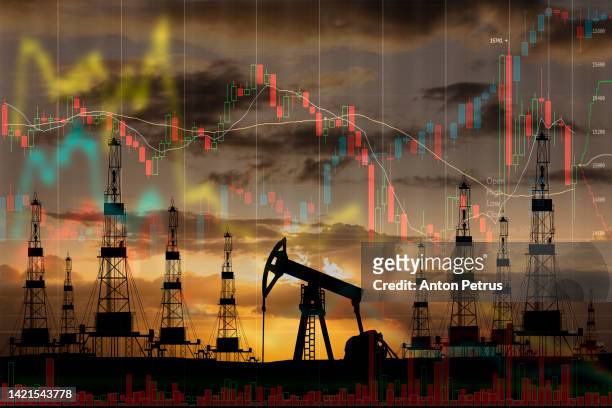 oil pump on the background of stock charts. world oil industry - oil prices stock pictures, royalty-free photos & images