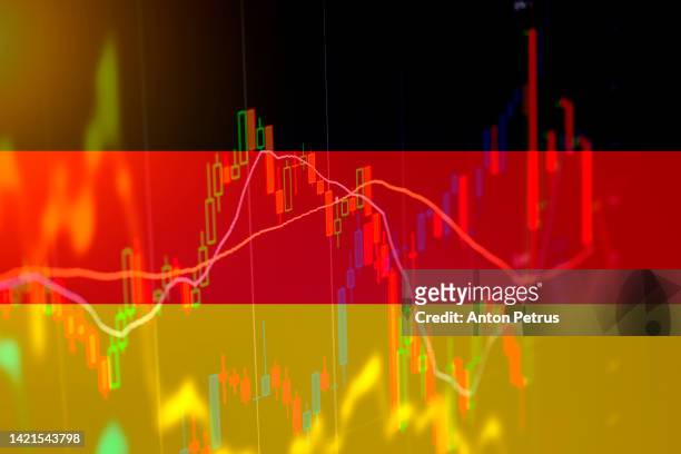 german flag on the background of  stock charts. economic crisis in germany - punishment stocks photos et images de collection
