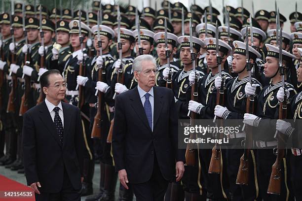 Chinese Premier Wen Jiabao accompanies Italian Prime Minister Mario Monti to view an honour guard during a welcoming ceremony at the Great Hall of...