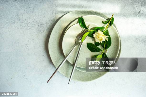 overhead view of a rustic place setting on a table with a white gardenia flower - gardenia stock pictures, royalty-free photos & images