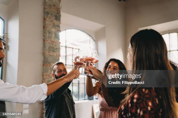 friends are celebrating together with wine glasses - winetasting stock pictures, royalty-free photos & images