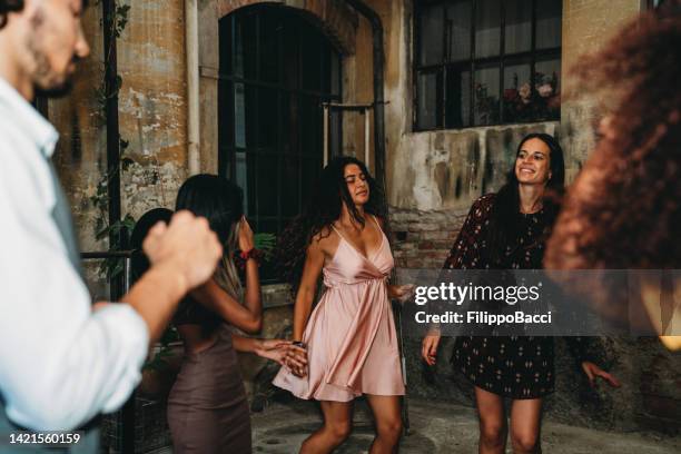 people are dancing in a loft during a party - arab festival stock pictures, royalty-free photos & images