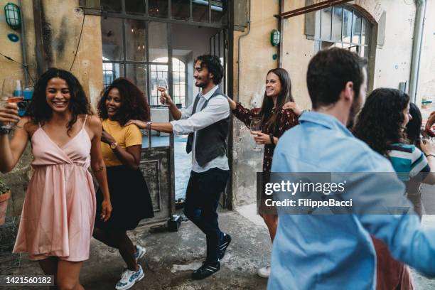 friends having fun together doing the conga line - conga stock pictures, royalty-free photos & images
