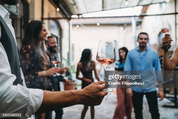 friends having fun together during a party - wijn proeven stockfoto's en -beelden