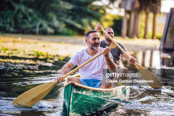 two men are rowing on the river - serbia nature stock pictures, royalty-free photos & images