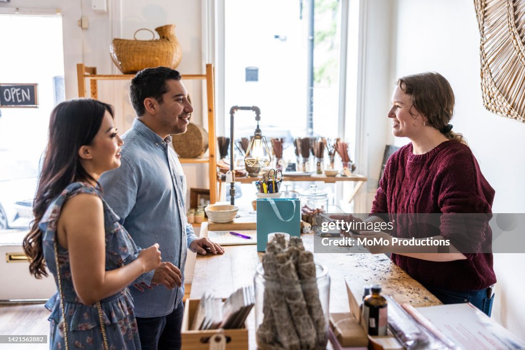 Young couple making a purchase at a female owned small business
