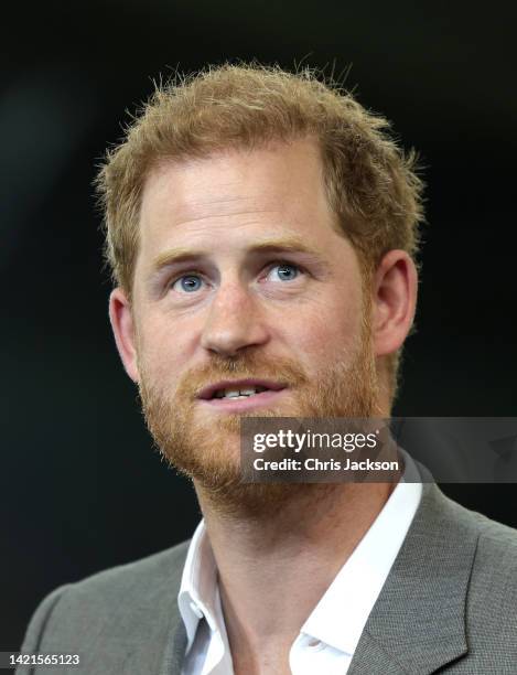 Meghan, Duchess of Sussex, Prince Harry, Duke of Sussex speak are presented with sports shirts with their children's names on them by Invictus...