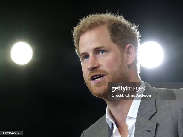 Meghan, Duchess of Sussex, Prince Harry, Duke of Sussex speak are presented with sports shirts with their children's names on them by Invictus...