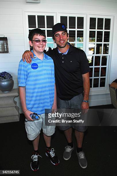 Make-A-Wish child Lucas Stroud and Greenbay Packers Quarterback Aaron Rodgers attend the 11th Annual Michael Jordan Celebrity Invitational hosted by...