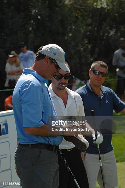 National Hockey League Hall of Fame player Mario Lemieux signs teamates shoe on the 18th hole at the 11th Annual Michael Jordan Celebrity...